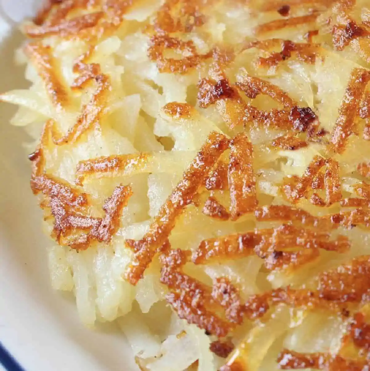 Close up of IHOP hash browns on a white plate. 