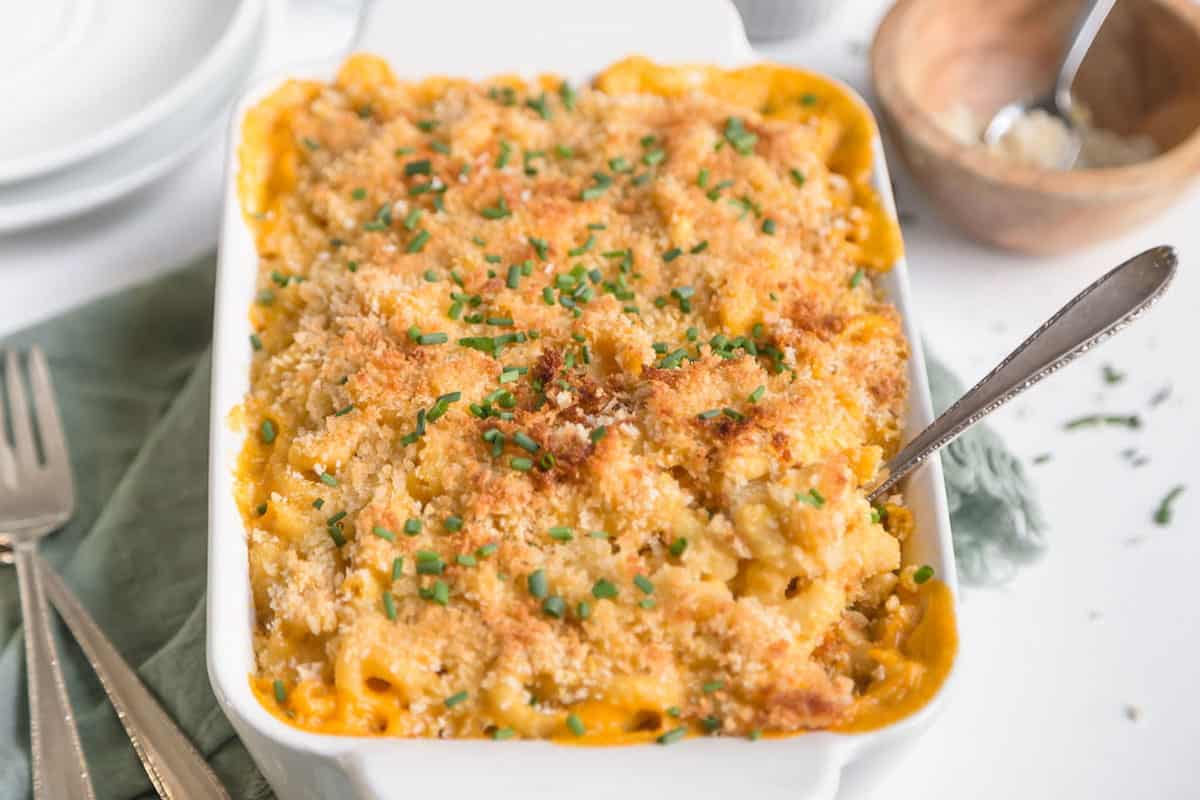Baked vegan mac and cheese in a white casserole dish. 