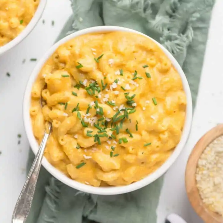 A top-down shot of vegan mac and cheese in a white bowl.