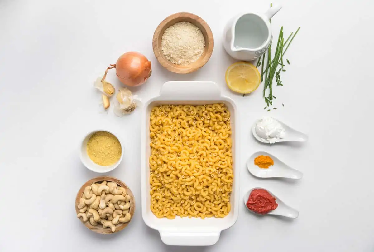 Ingredients laid out for a vegan mac and cheese recipe against a white background.