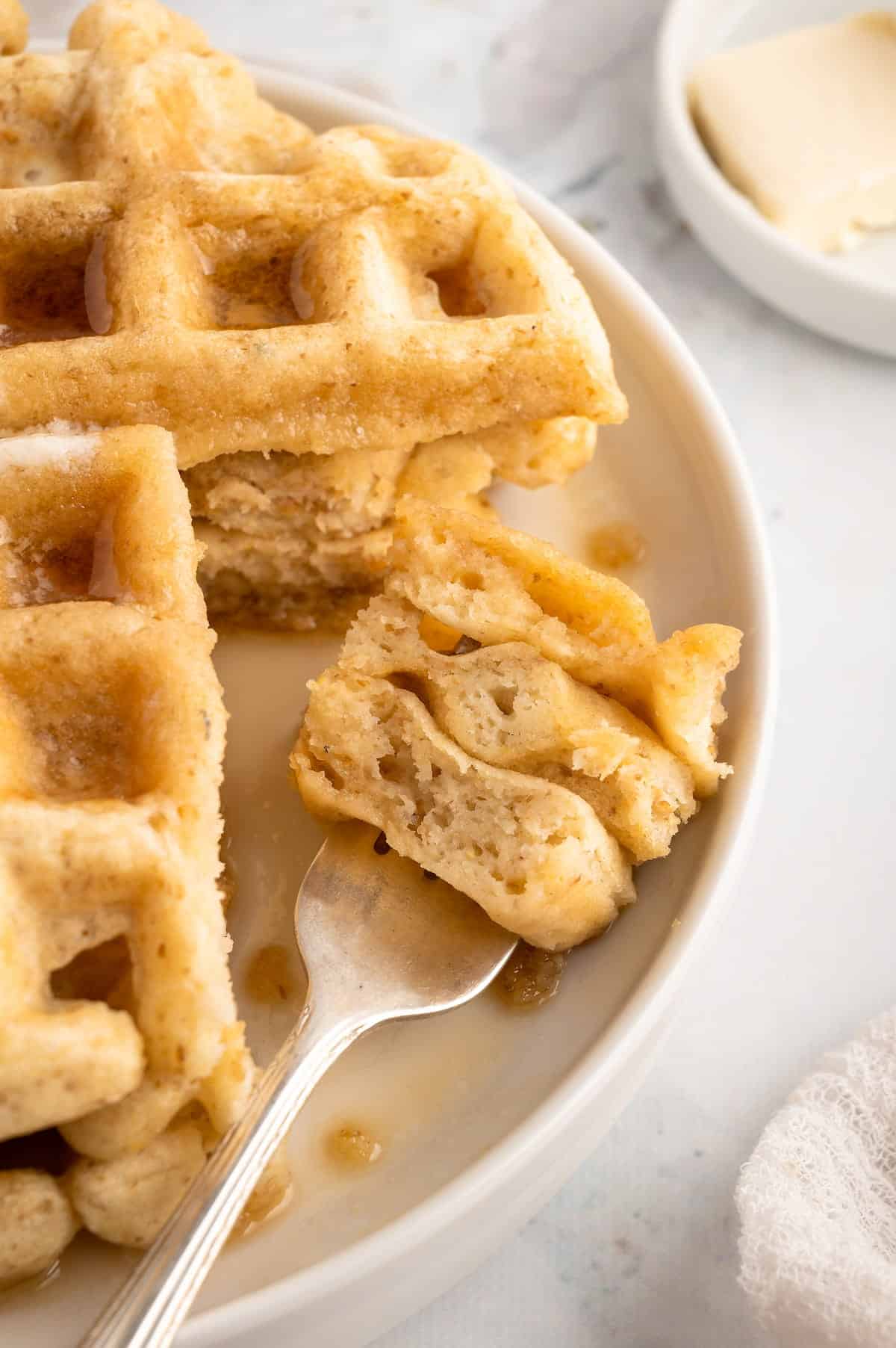 Vegan waffles cut to show the fluffy inside texture.