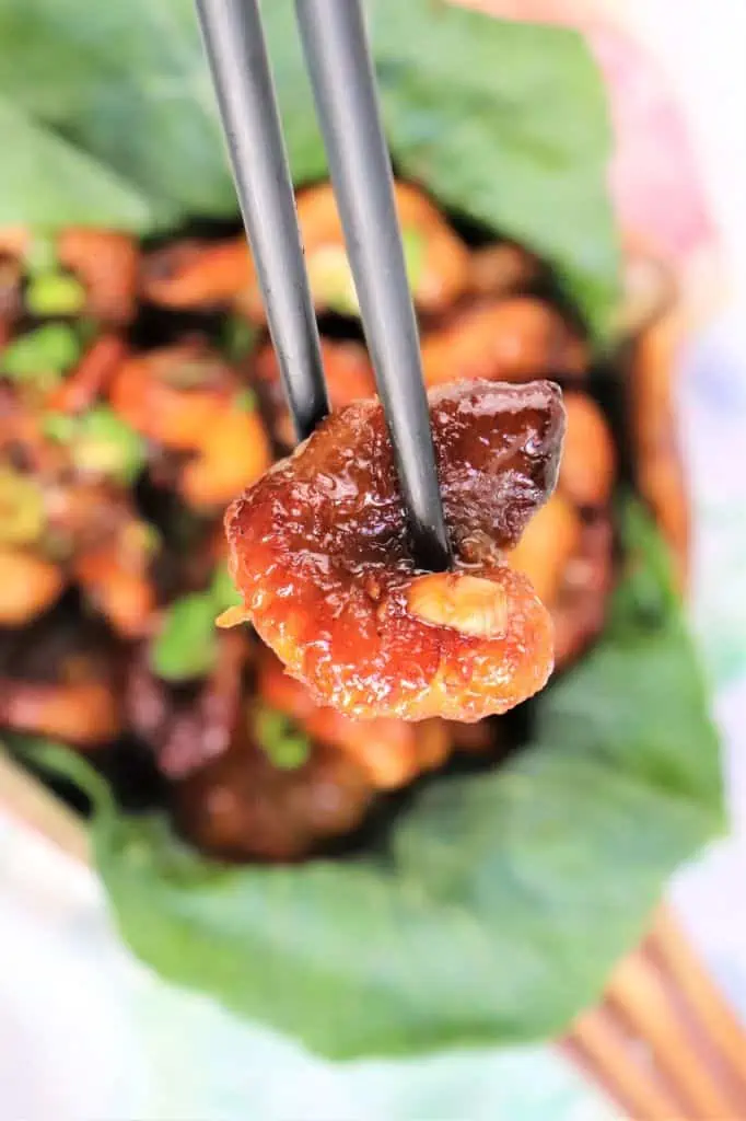 vegan honey garlic shrimp held up by chopsticks