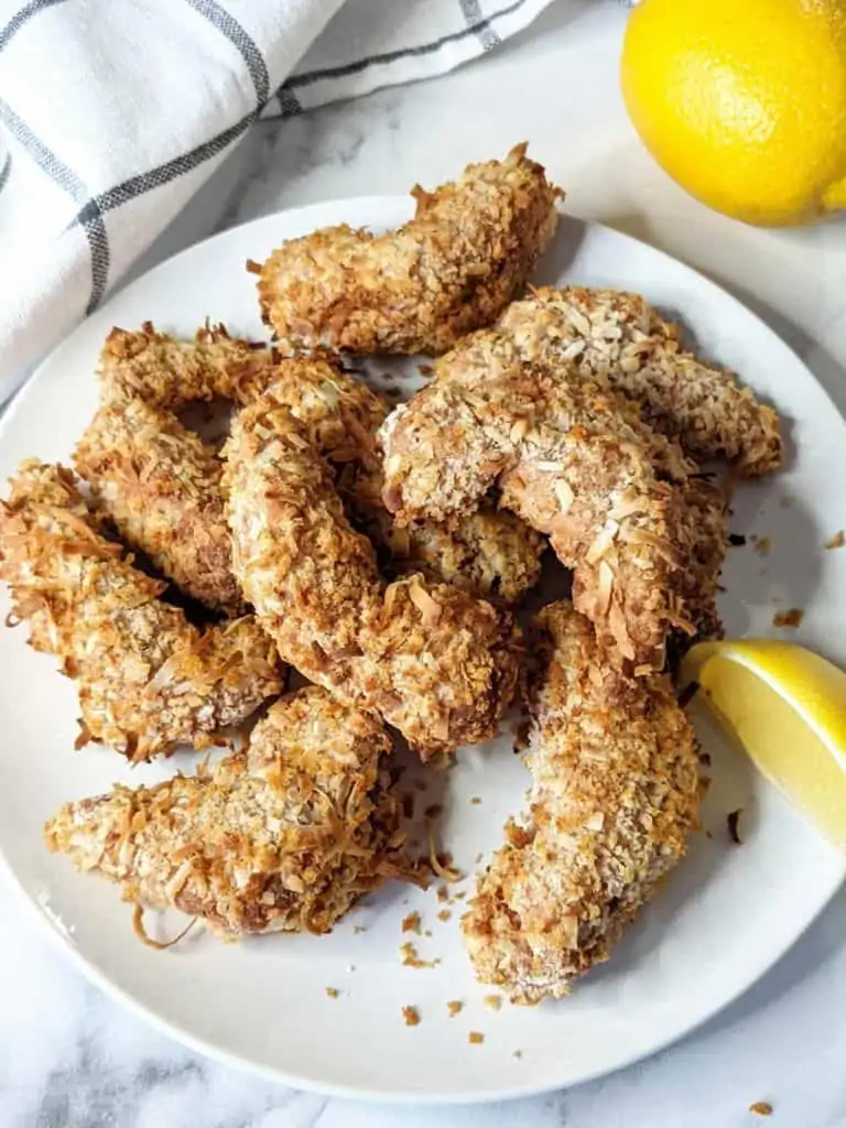 vegan coconut breaded fried shrimp served on a plate with lemon