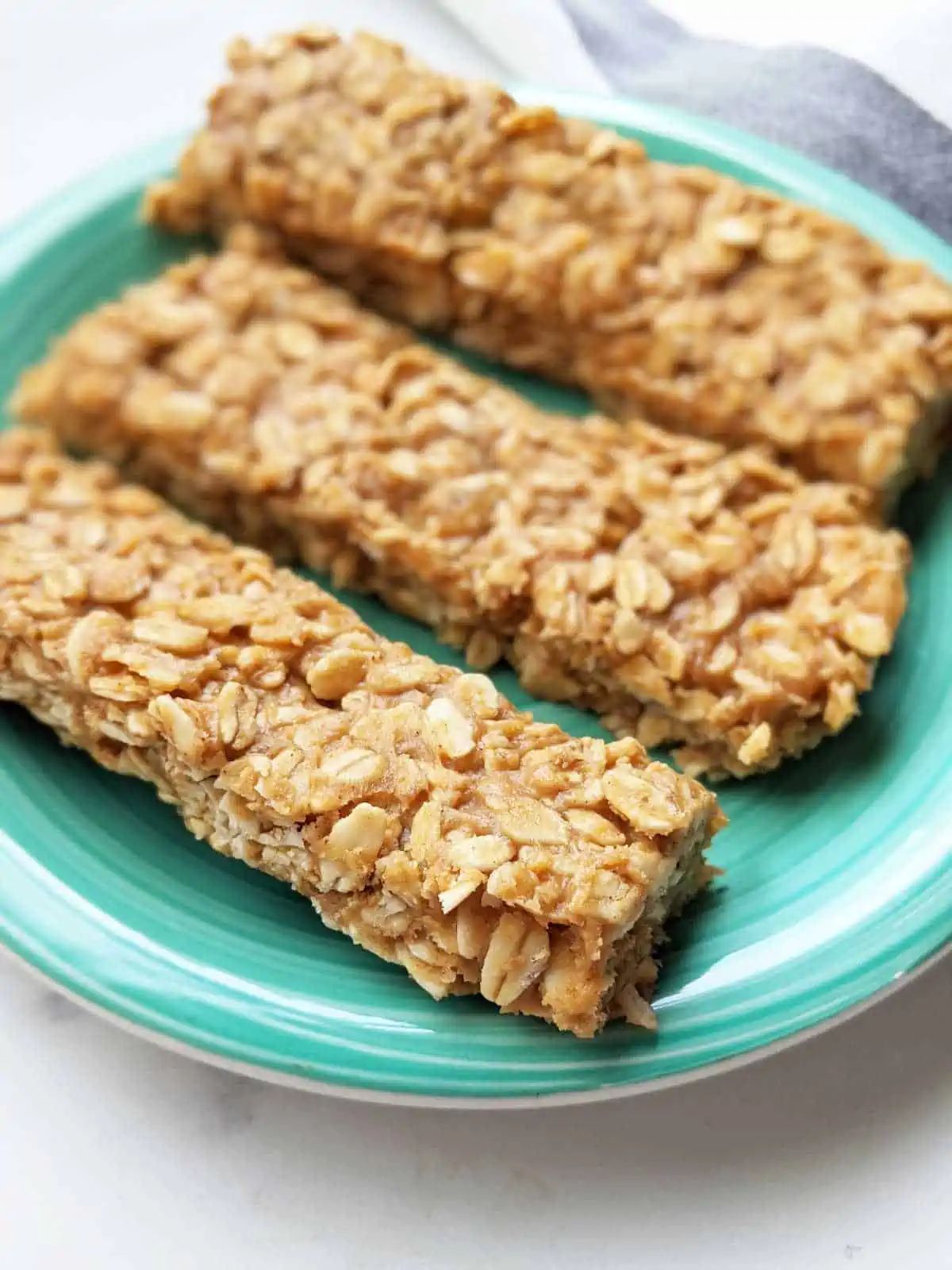 Three vegan gluten free granola bars on a plate.