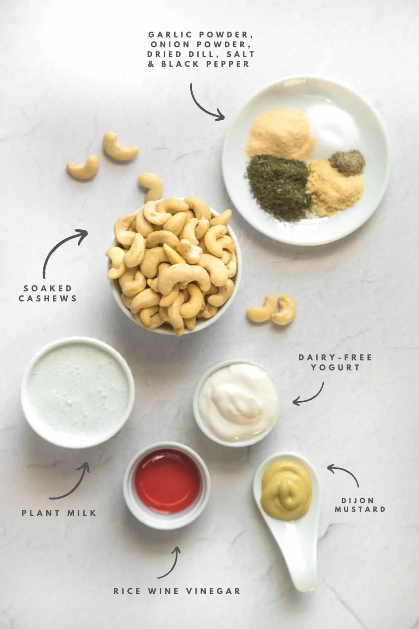Creamy oil free vegan dill dressing ingredients flatlay soaked cahsews milk spices