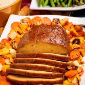 Sliced Plant Based Seitan Turkey Roast with Roasted Veggies for Thanksgiving