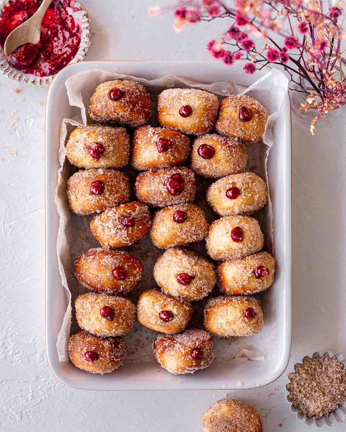 vegan air fried donuts filled with jelly in a white tray