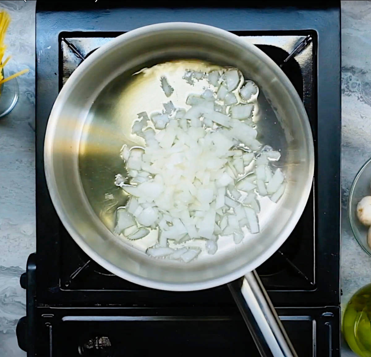 Onion and garlic sauteeing in a large pan.