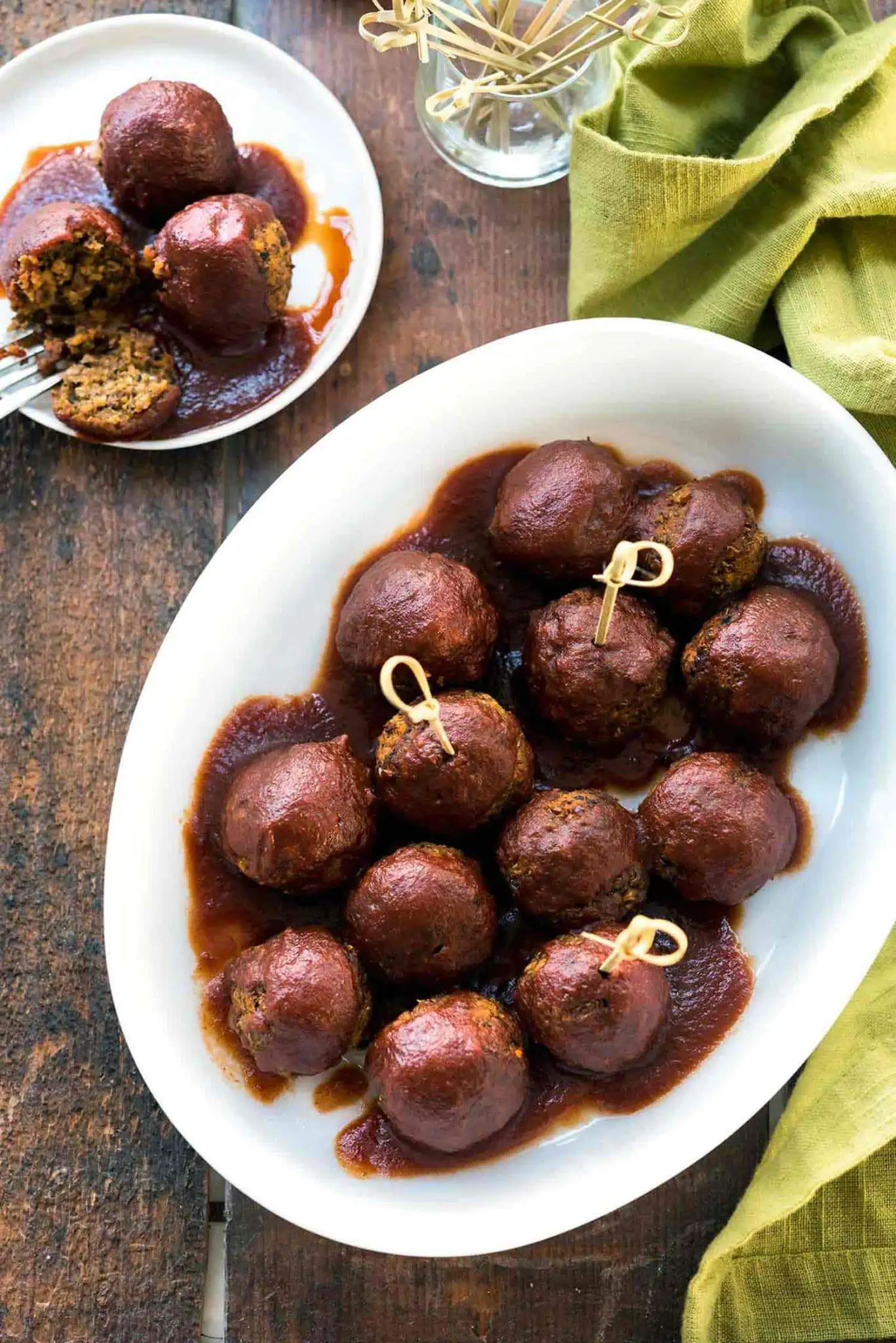 lentil meatballs on a plate covered in sauce