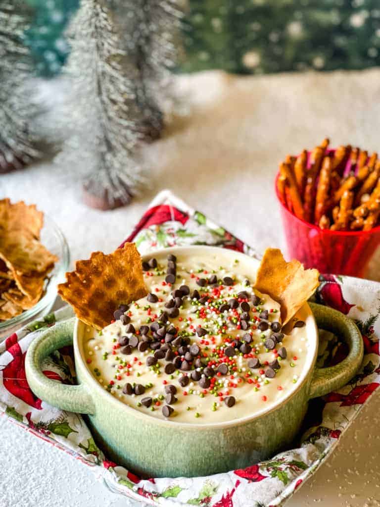 vegan cannoli dip with sprinkles, chocolate chips, and waffle cone pieces
