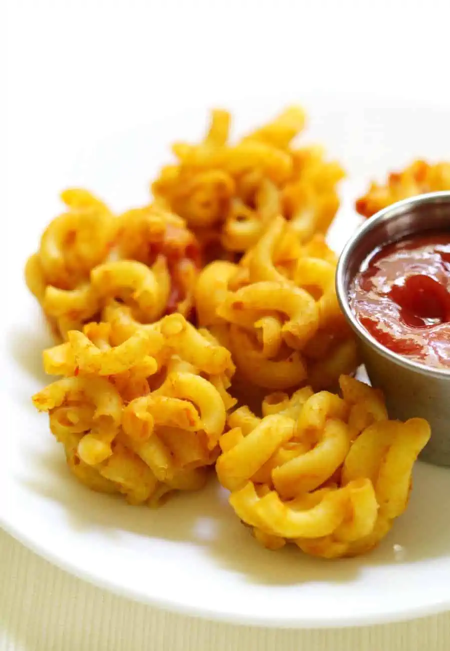 Mini mac and cheese bites with ketchup on the side.