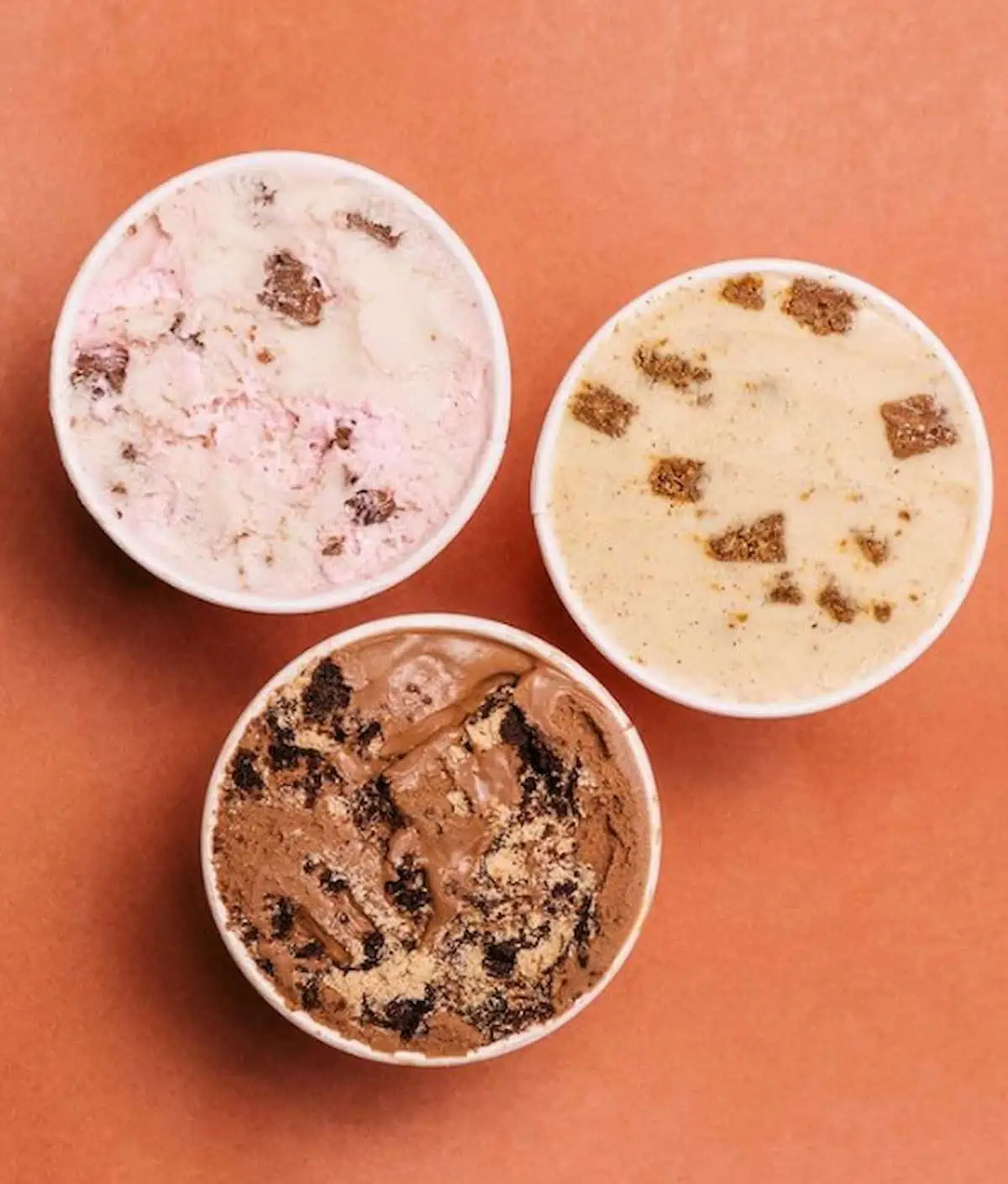 Bird's-eye view of three open pints of Frankie & Jo's vegan ice cream.