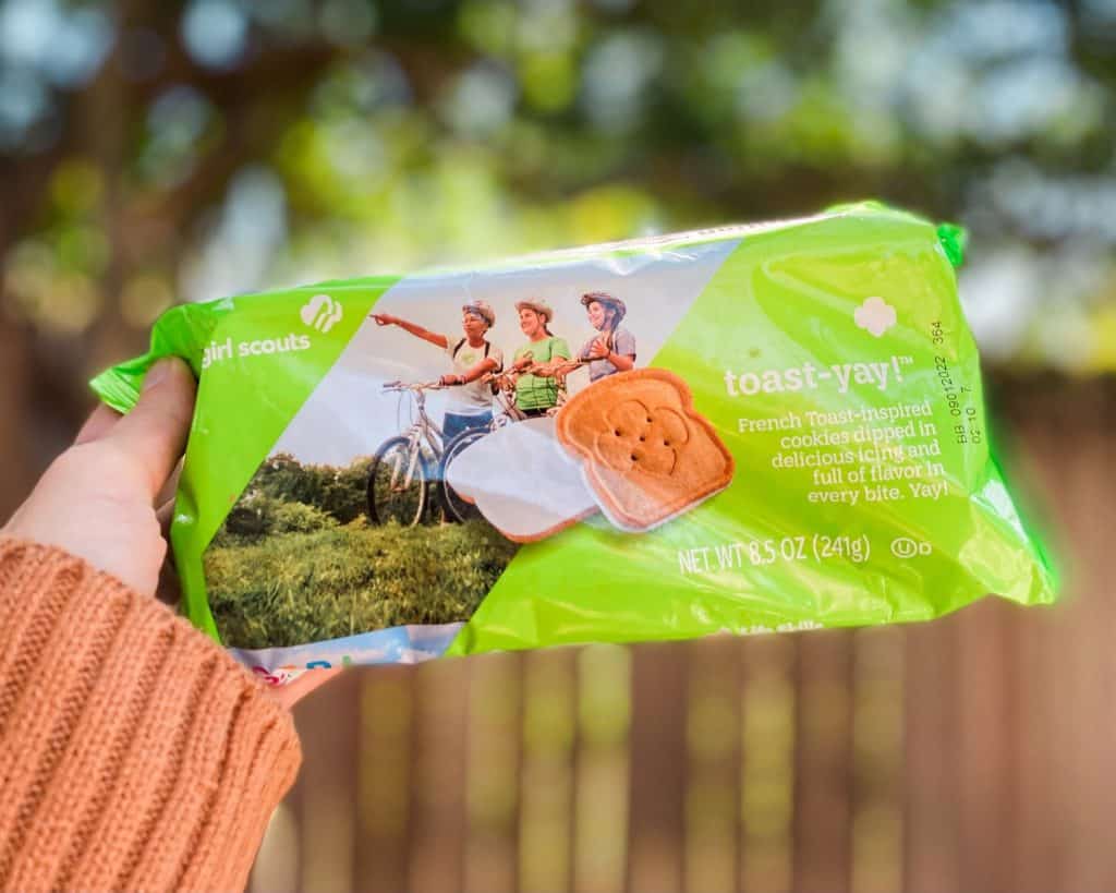 Toast Yay Girl Scouts cookies in a new package 2022 held out in a hand