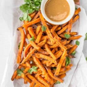 air fryer sweet potato fries on a plate with a dipping sauce