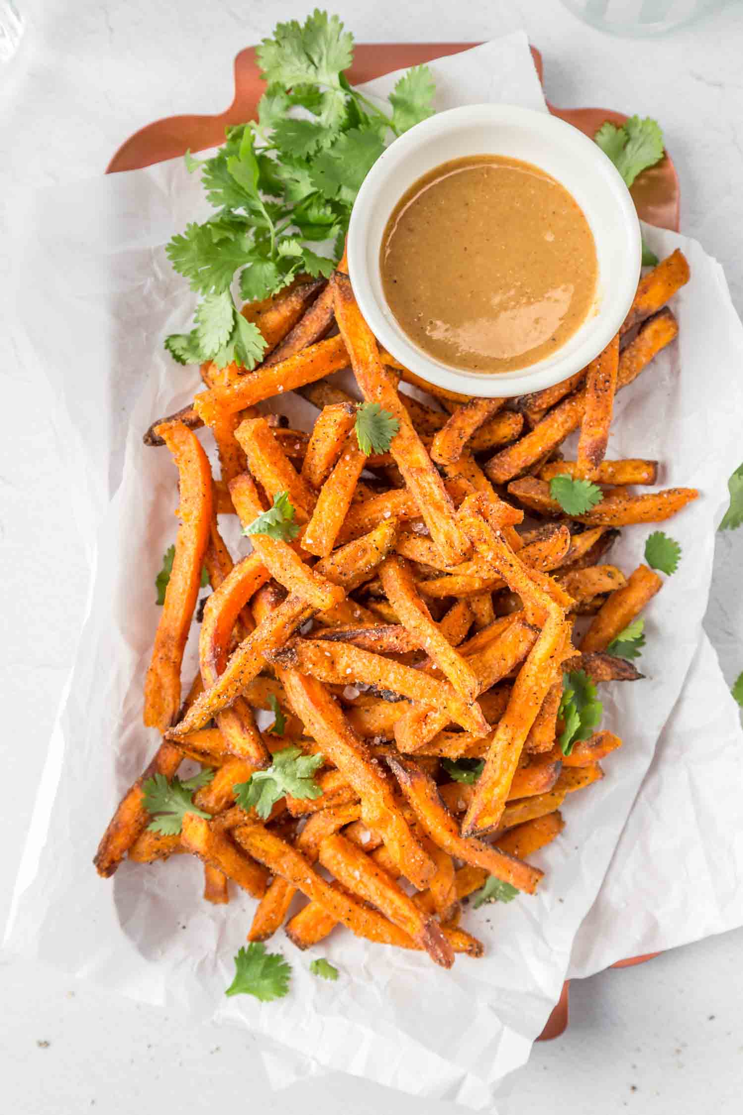 air fryer sweet potato fries on a plate with a dipping sauce