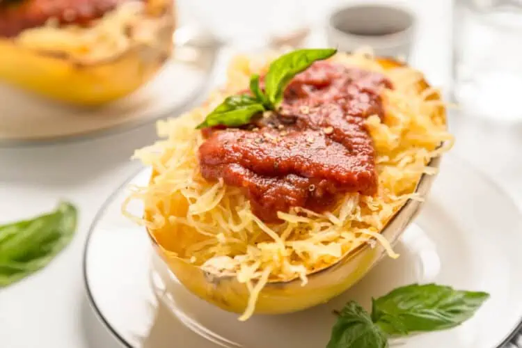 the perfect vegan air fryer spaghetti squash topped with marinara and basil