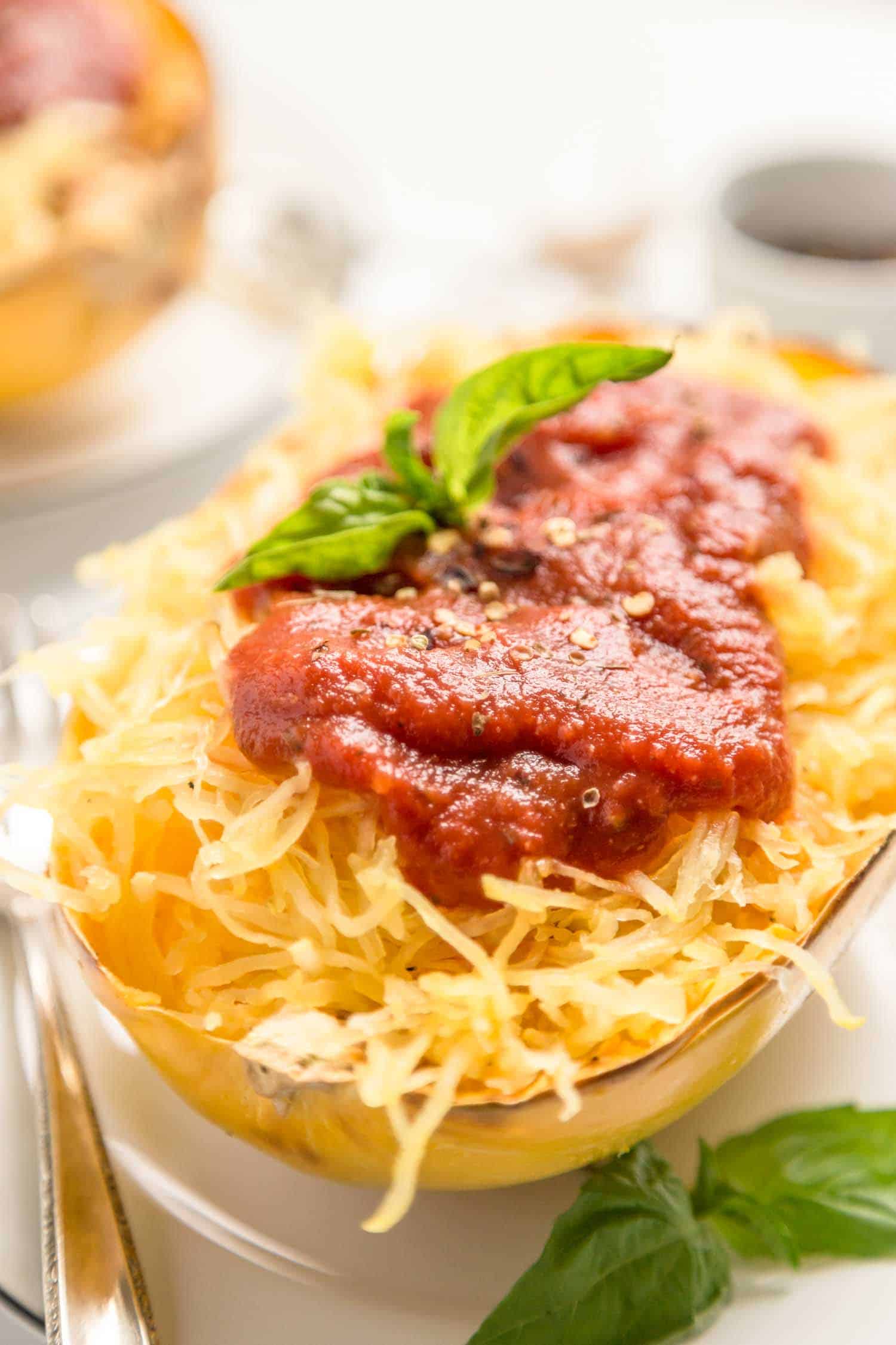 Cooked spaghetti squash turned into healthy noodles with marinara sauce on top.