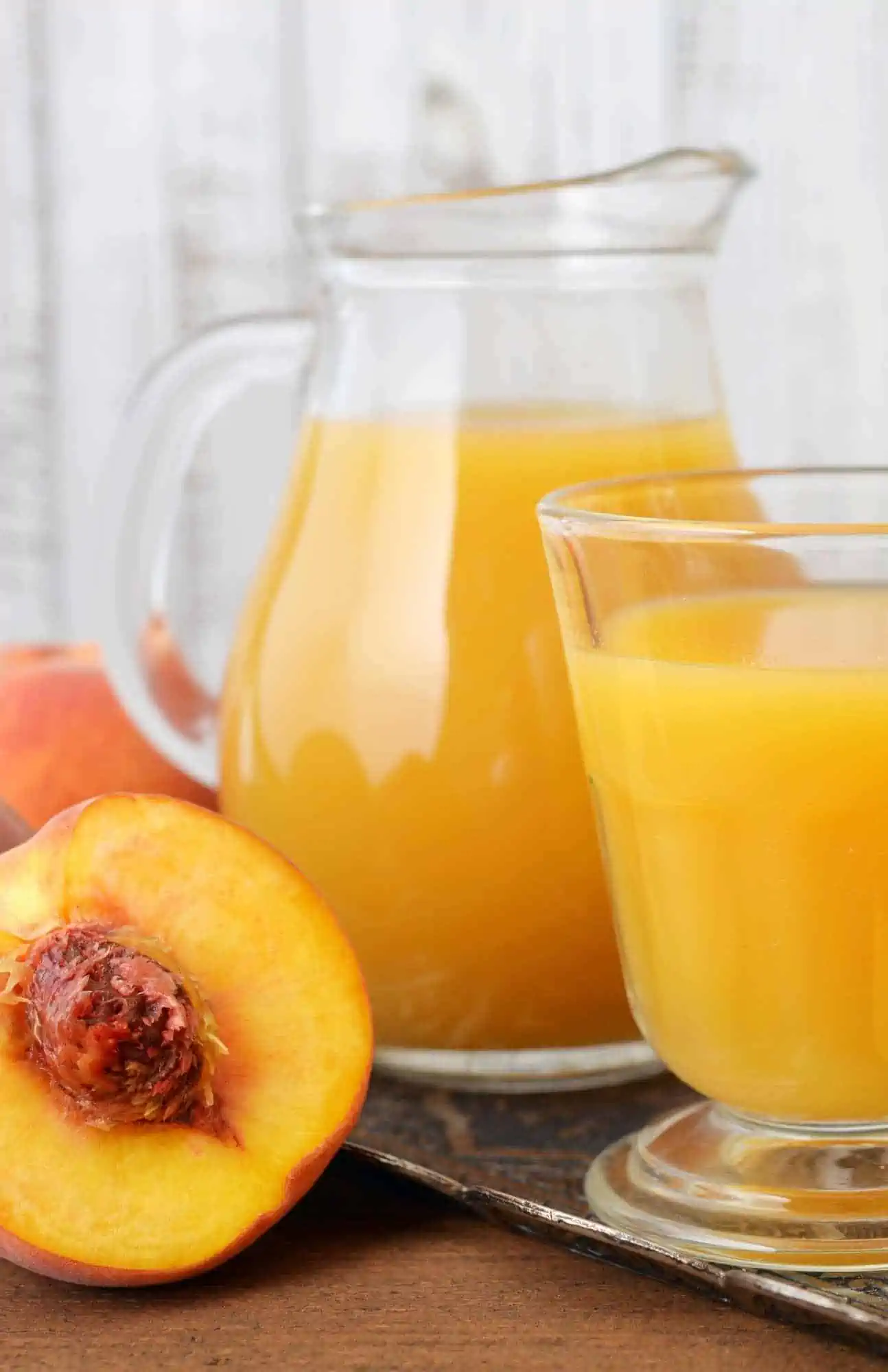 summer peach juice served in a large glass pitcher