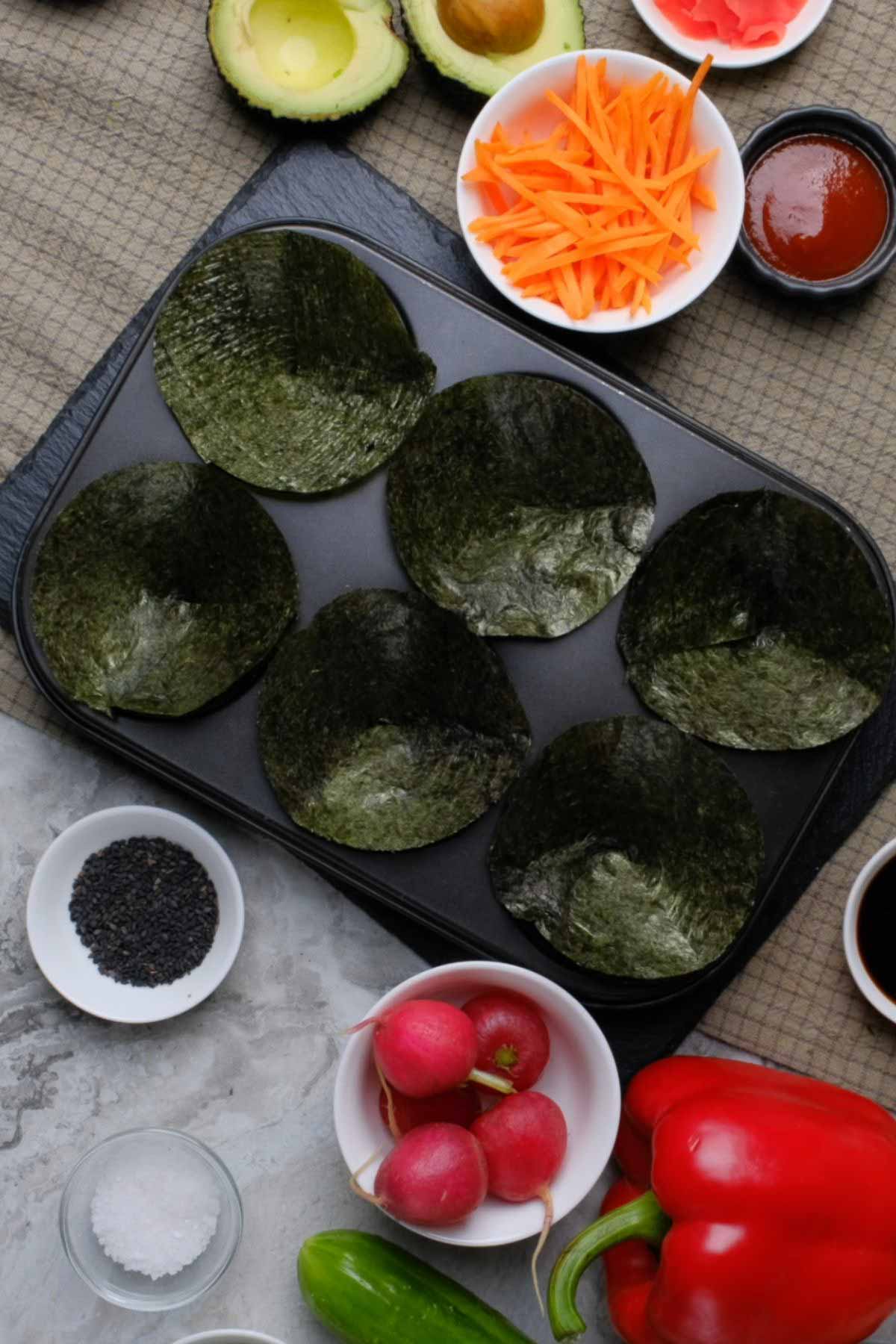 Nori sheets cut into circles and placed in a muffin tin.
