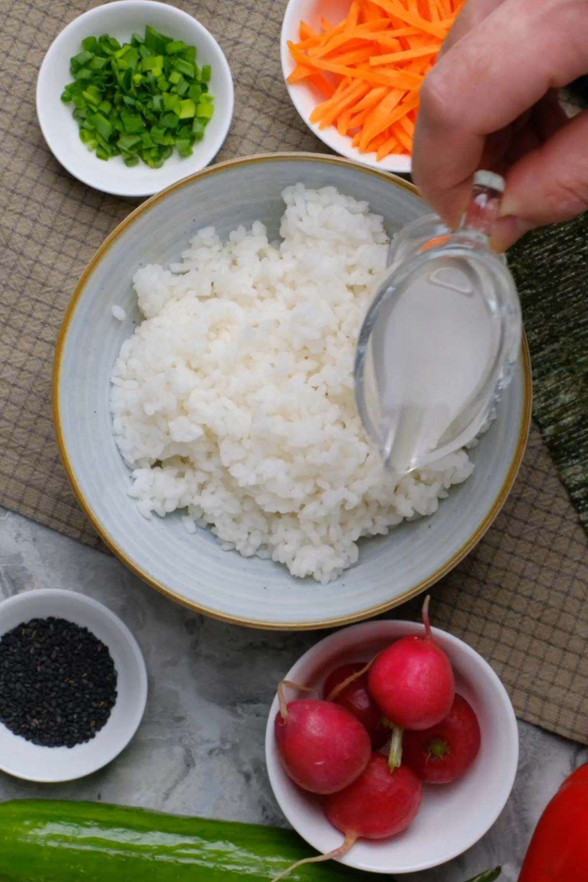 Seasoning poured over sushi rice.