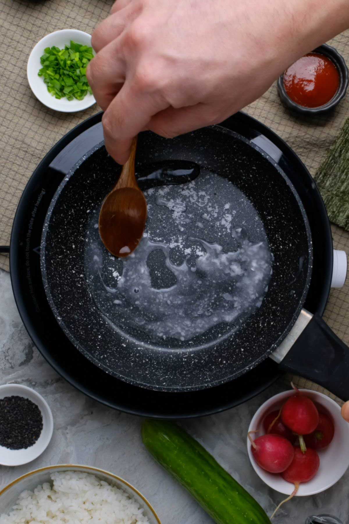 Sushi rice seasoning in a pan.