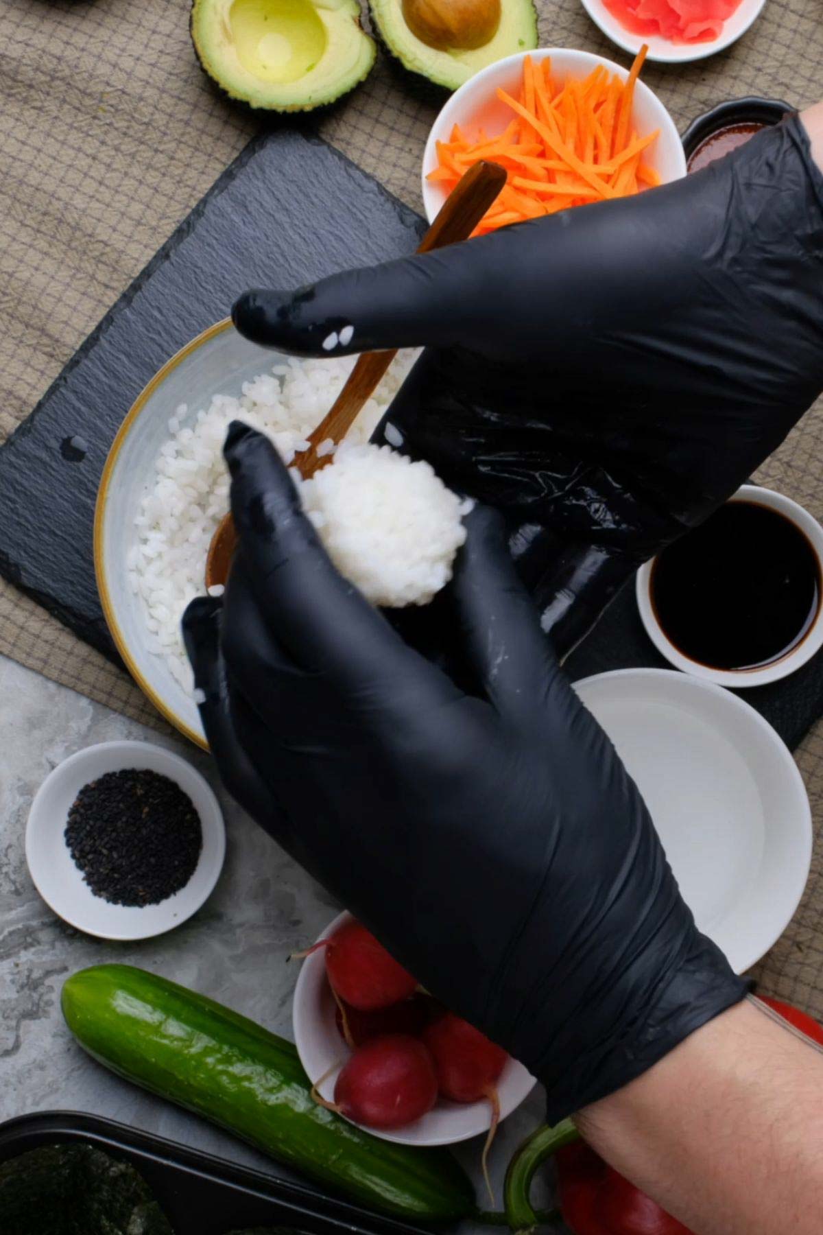 A sushi ball being assembled by hand.