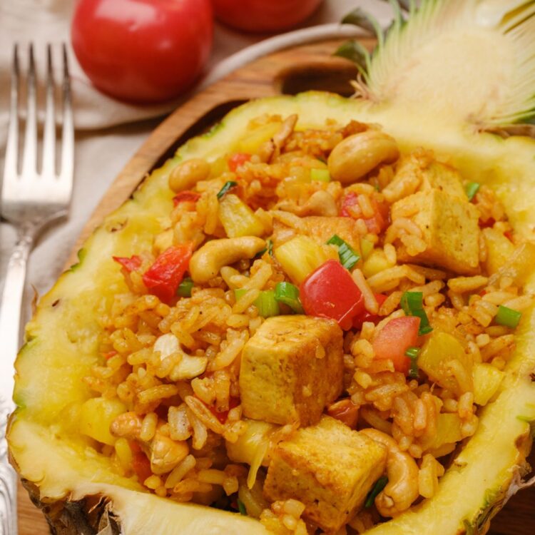 Vegan pineapple fried rice served in a pineapple.