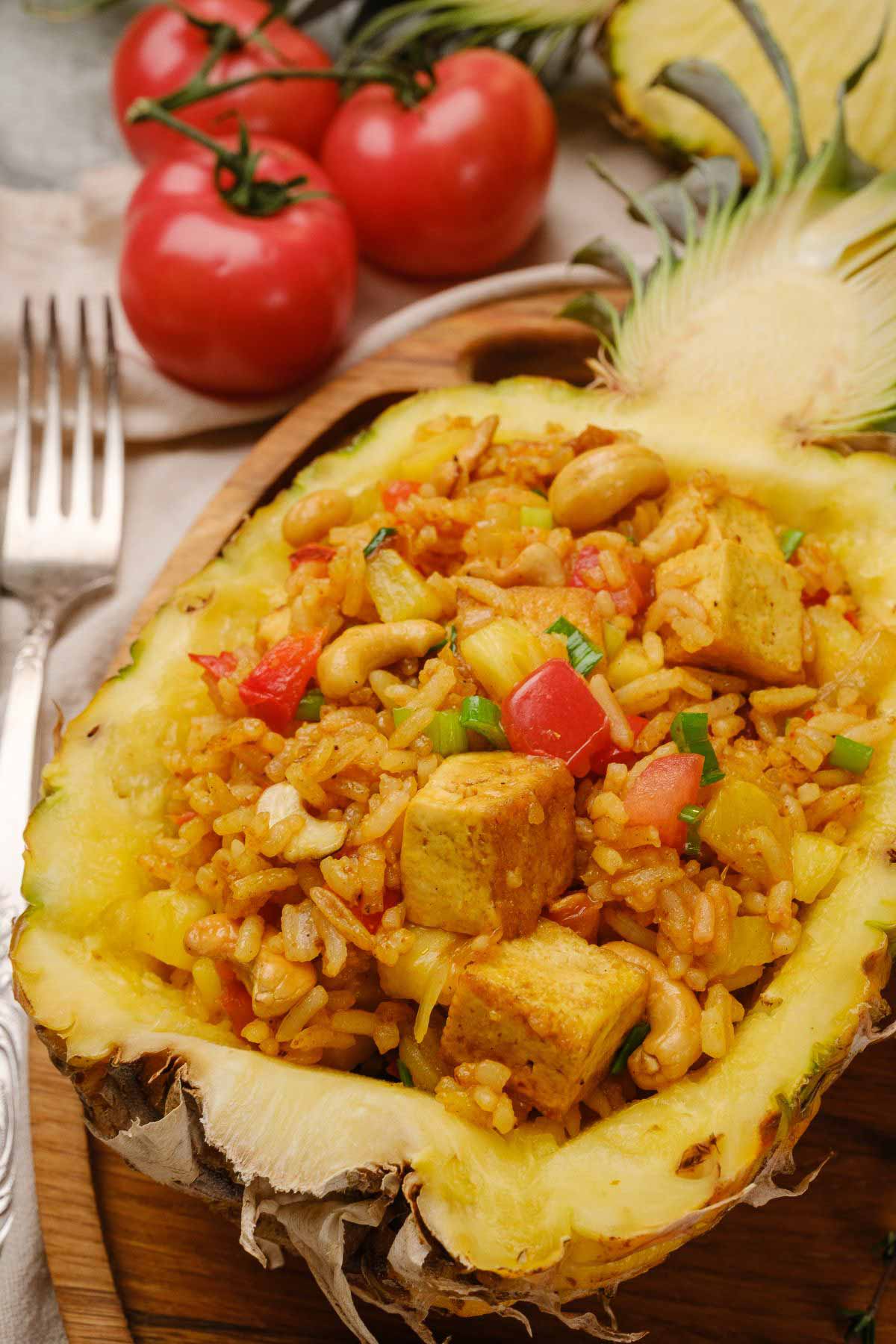 Vegan pineapple fried rice served in a hollowed-out pineapple.