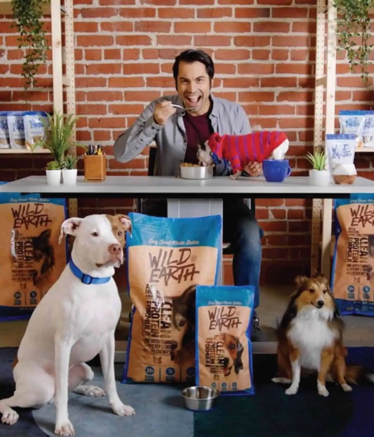 Wild Earth dog food founder Ryan Bethencourt eating the dog food with dogs. 