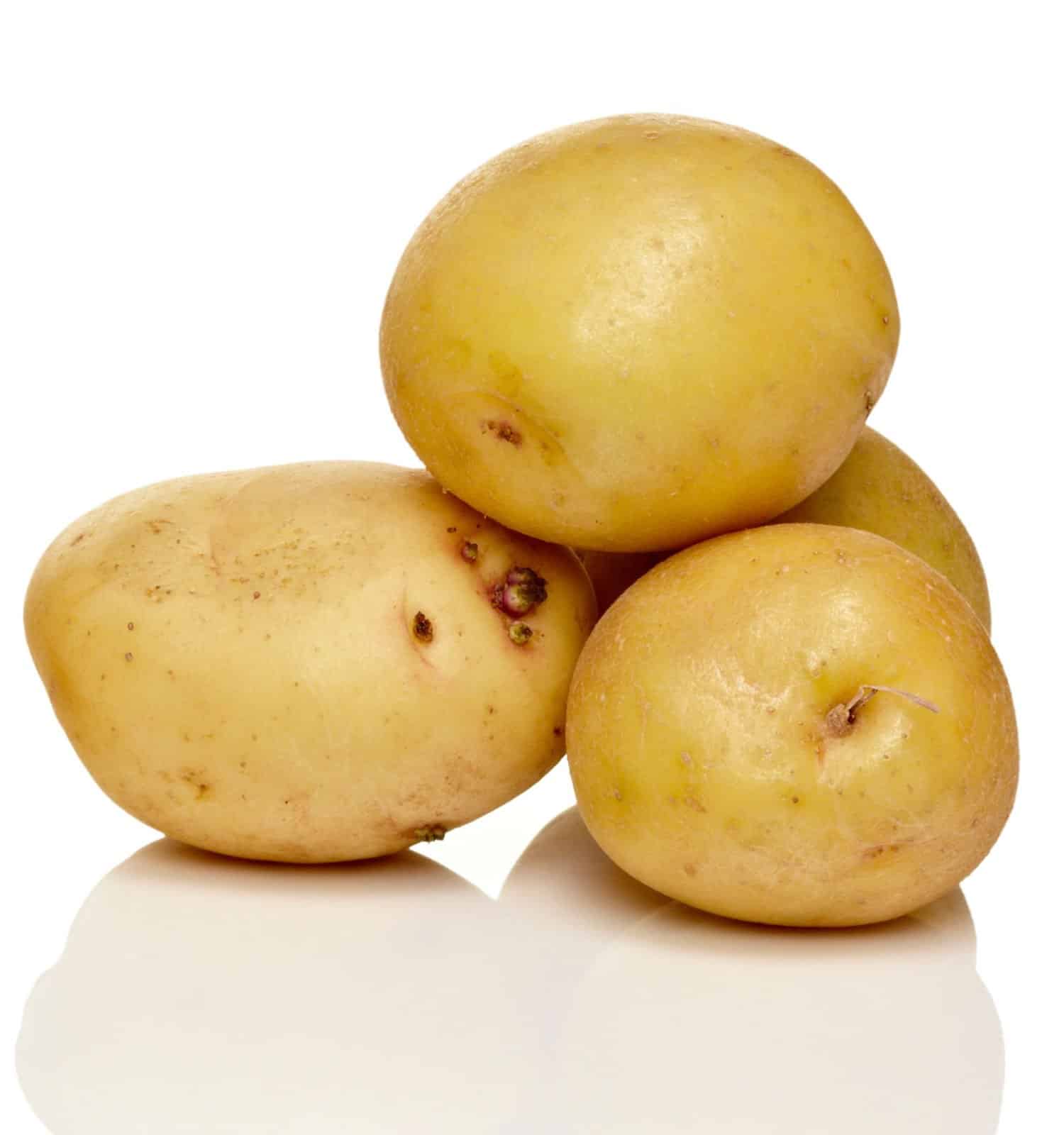 four yellow yukon gold potatoes in a pile