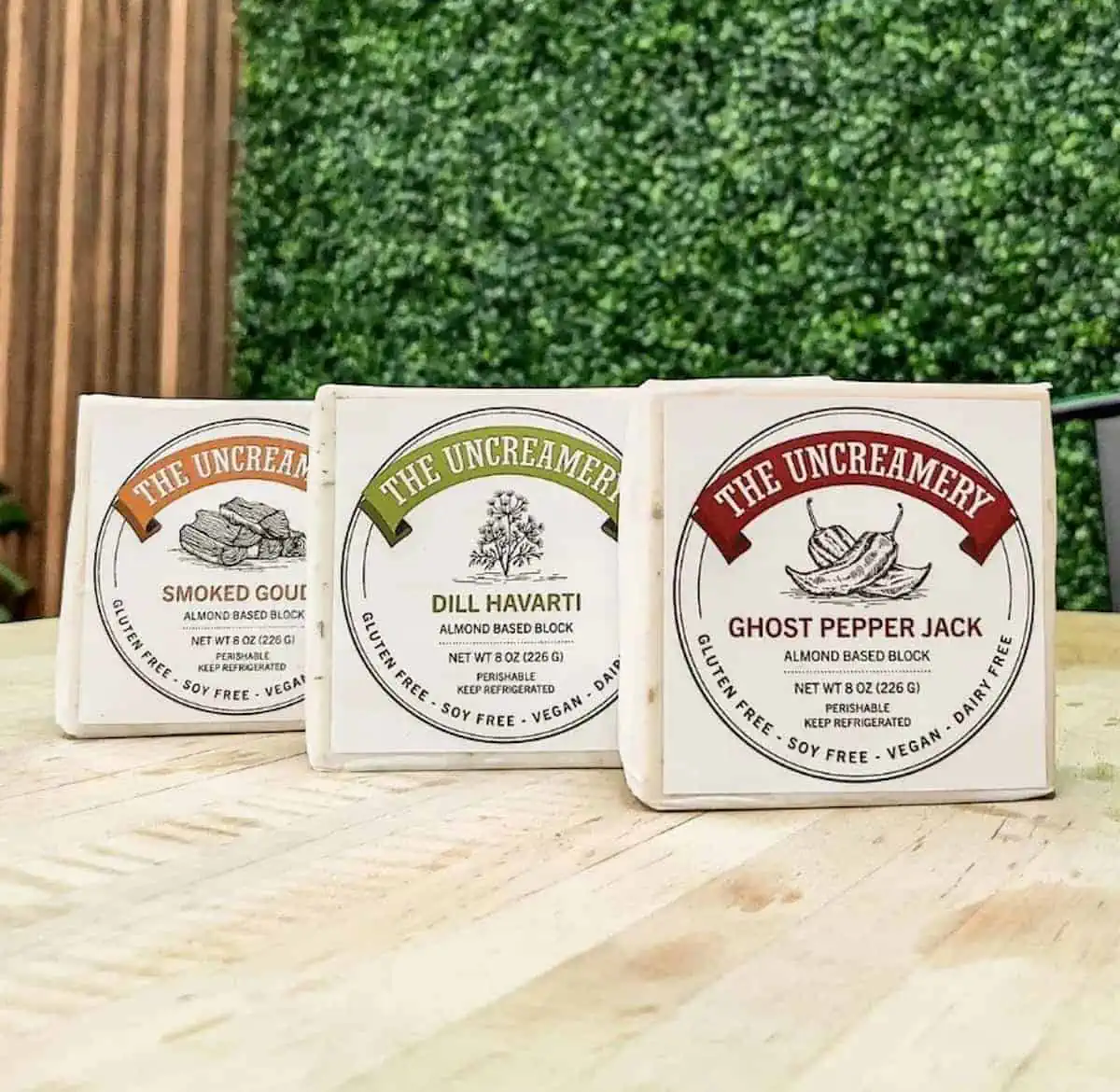 Three packages of The Uncreamery vegan cheese blocks.