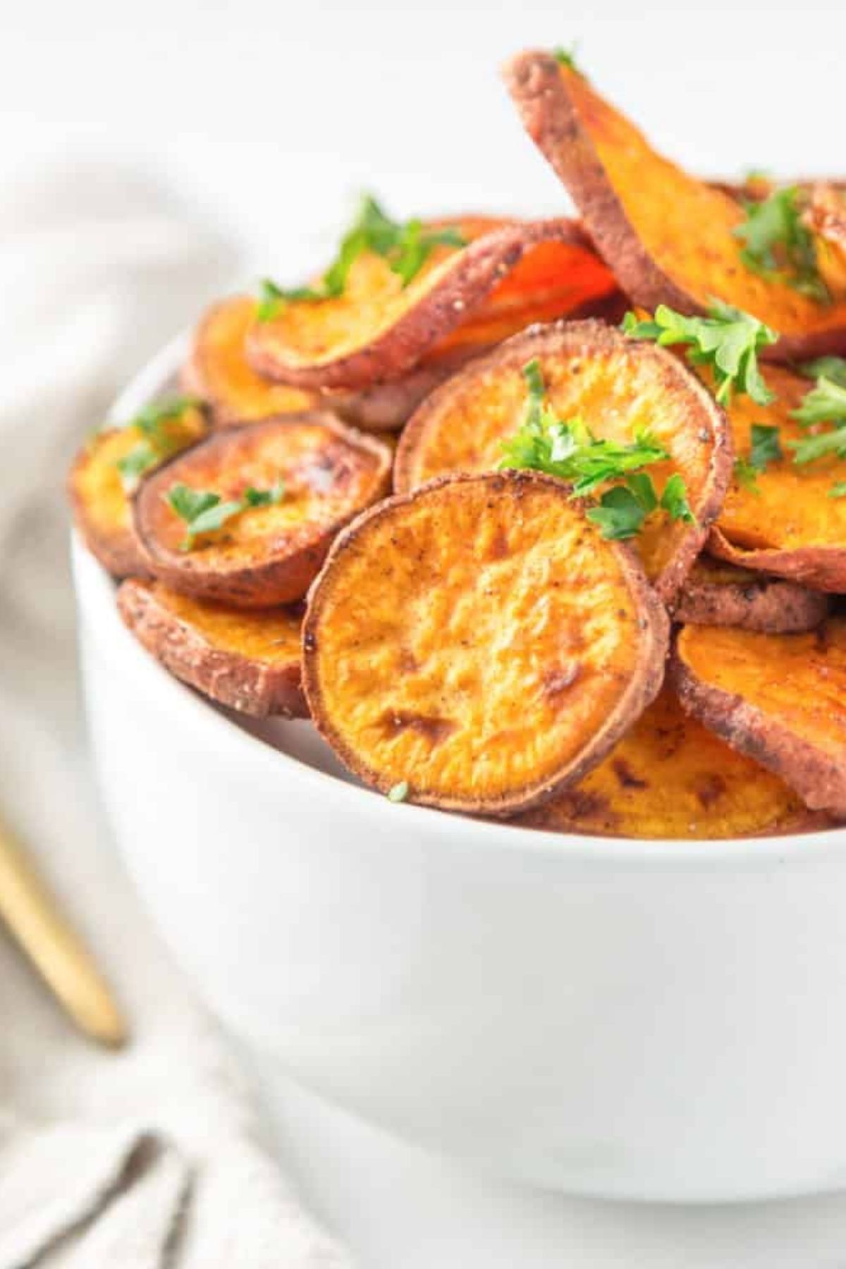 Roasted sweet potatoes sprinkled with parsley.