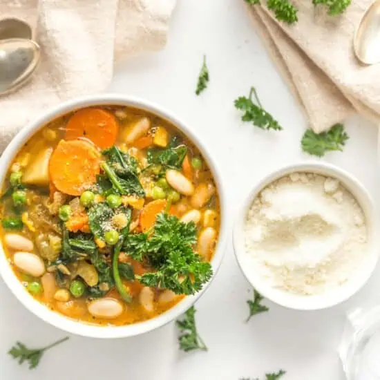 best vegan stew recipe served in white bowls with plant based parm