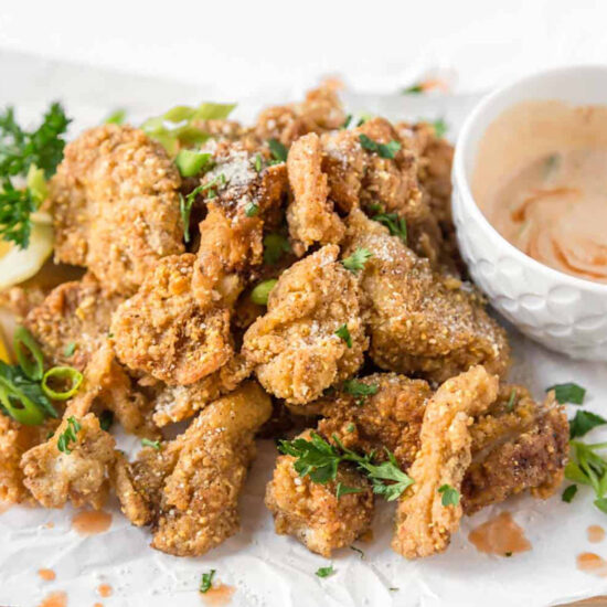 Crispy fried oyster mushrooms vegan recipe served with spicy dairy free dipping sauce.