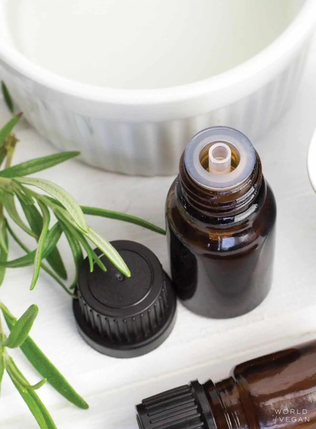 Bottle of essential oil with its lid off.