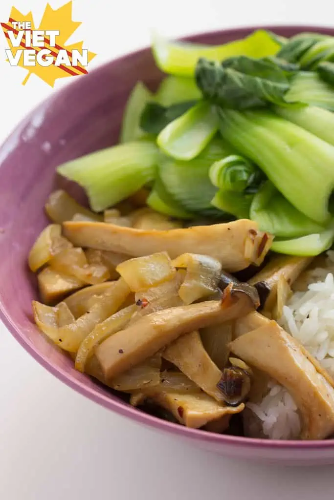 stir-fried oyster mushrooms in a bowl with steamed rice and blanched bok choy