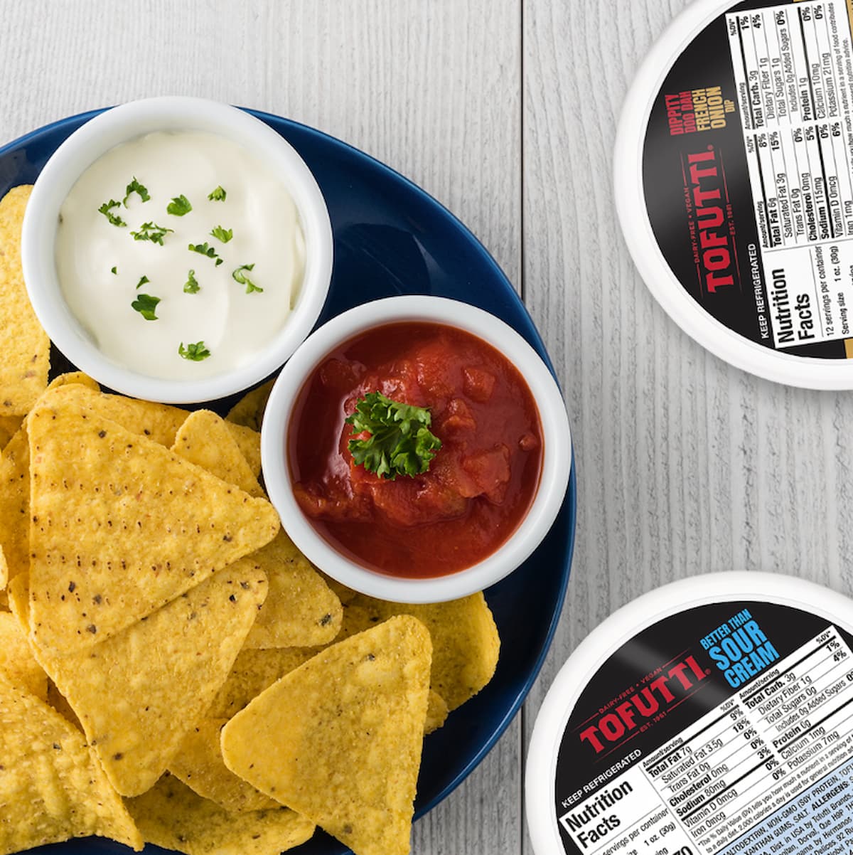 Tofutti vegan sour cream in a bowl next to salsa and chips.