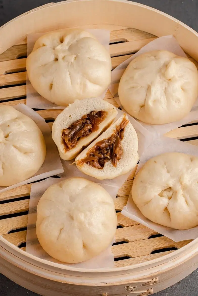 vegan siopao asado buns on a steamer filled with oyster mushrooms