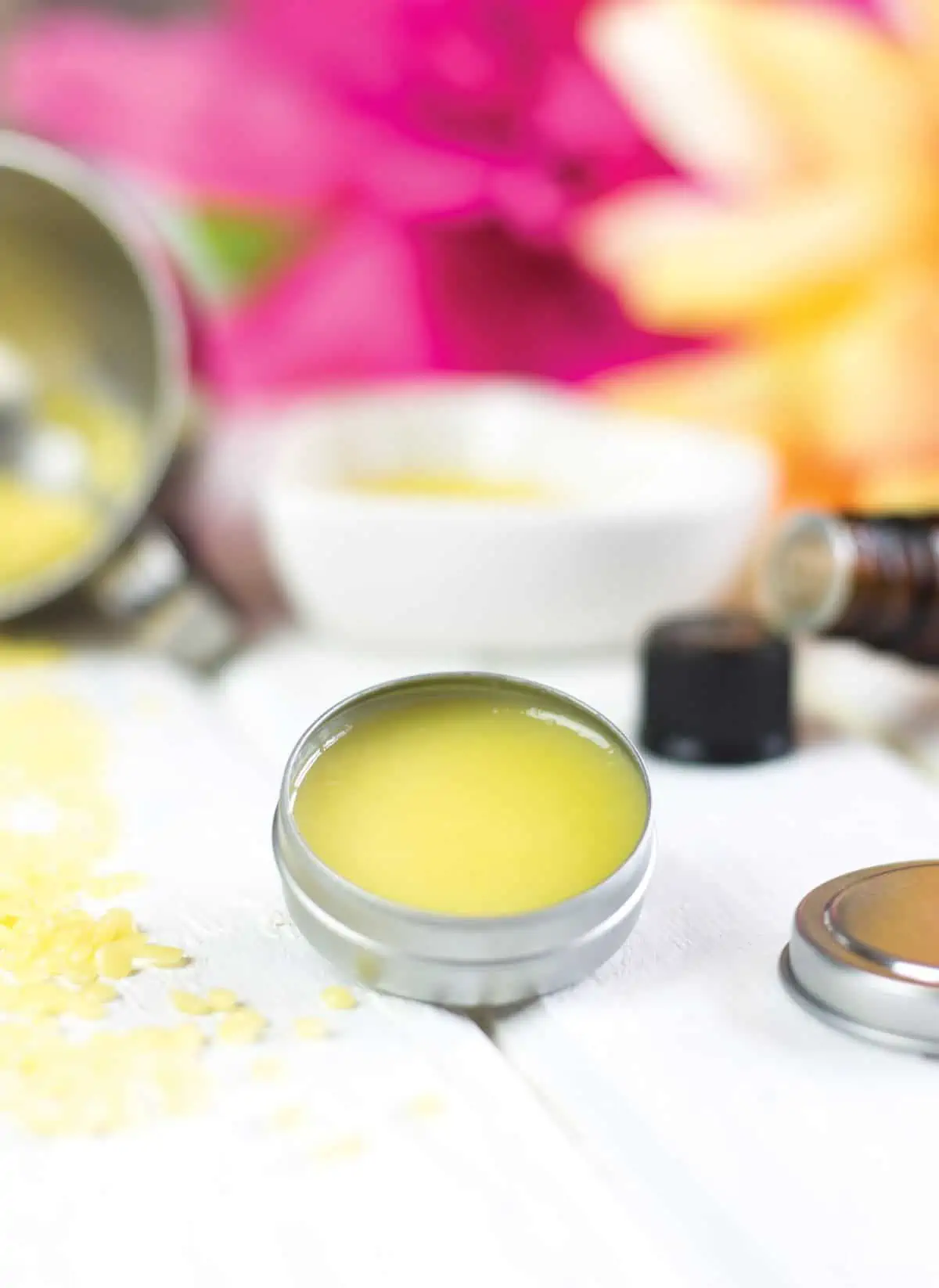 Solid perfume in a tin jar with candelilla wax sprinkled around it.