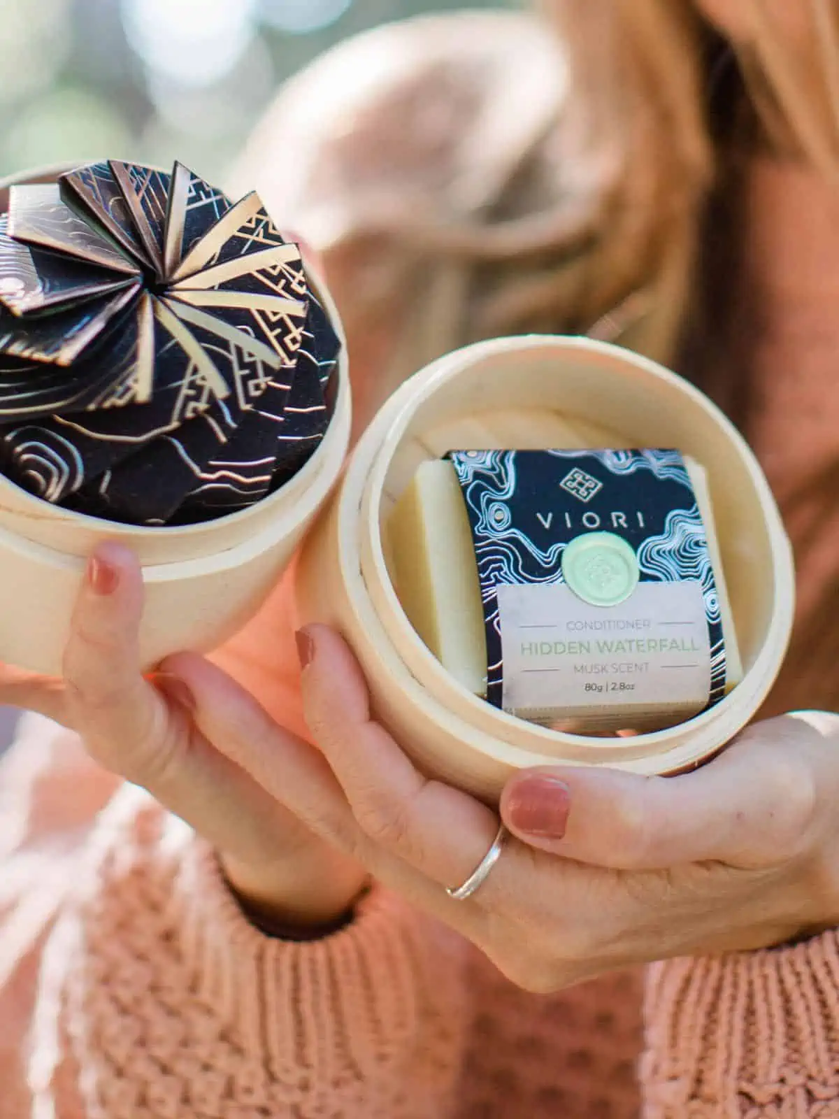 Michelle Cehn holding out a Viori eco-friendly shampoo bar. 