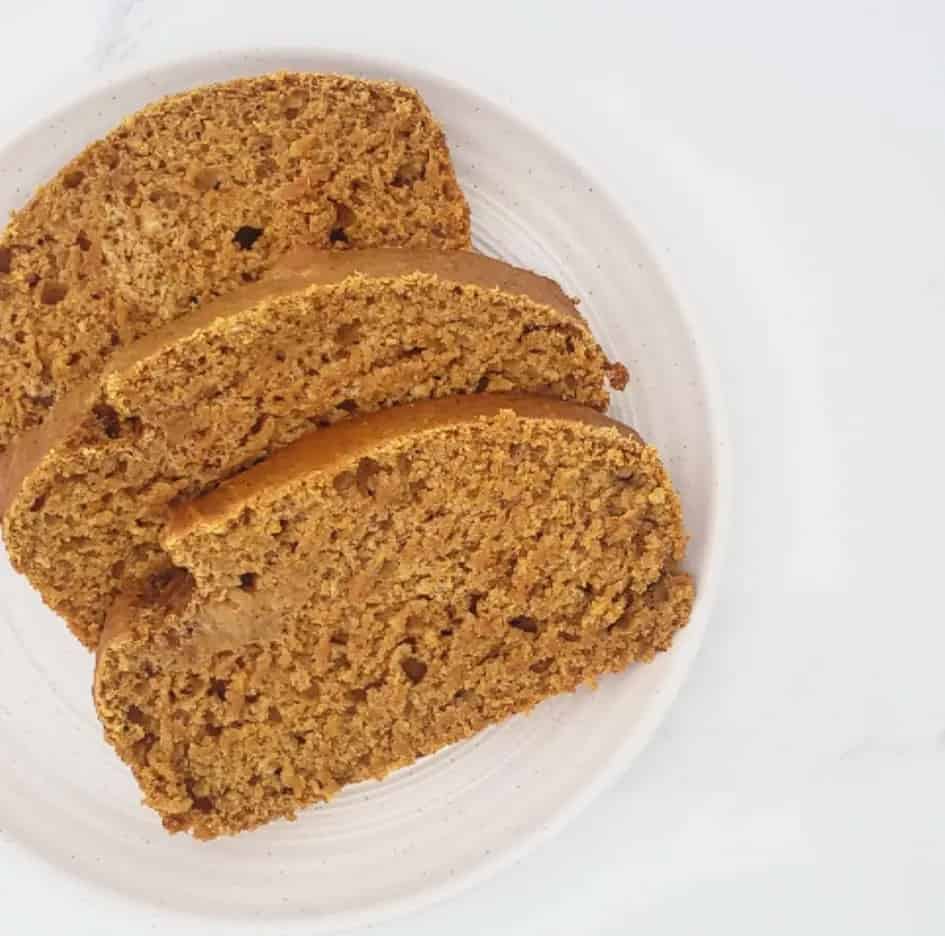 vegan pumpkin spice bread sliced on a white plate