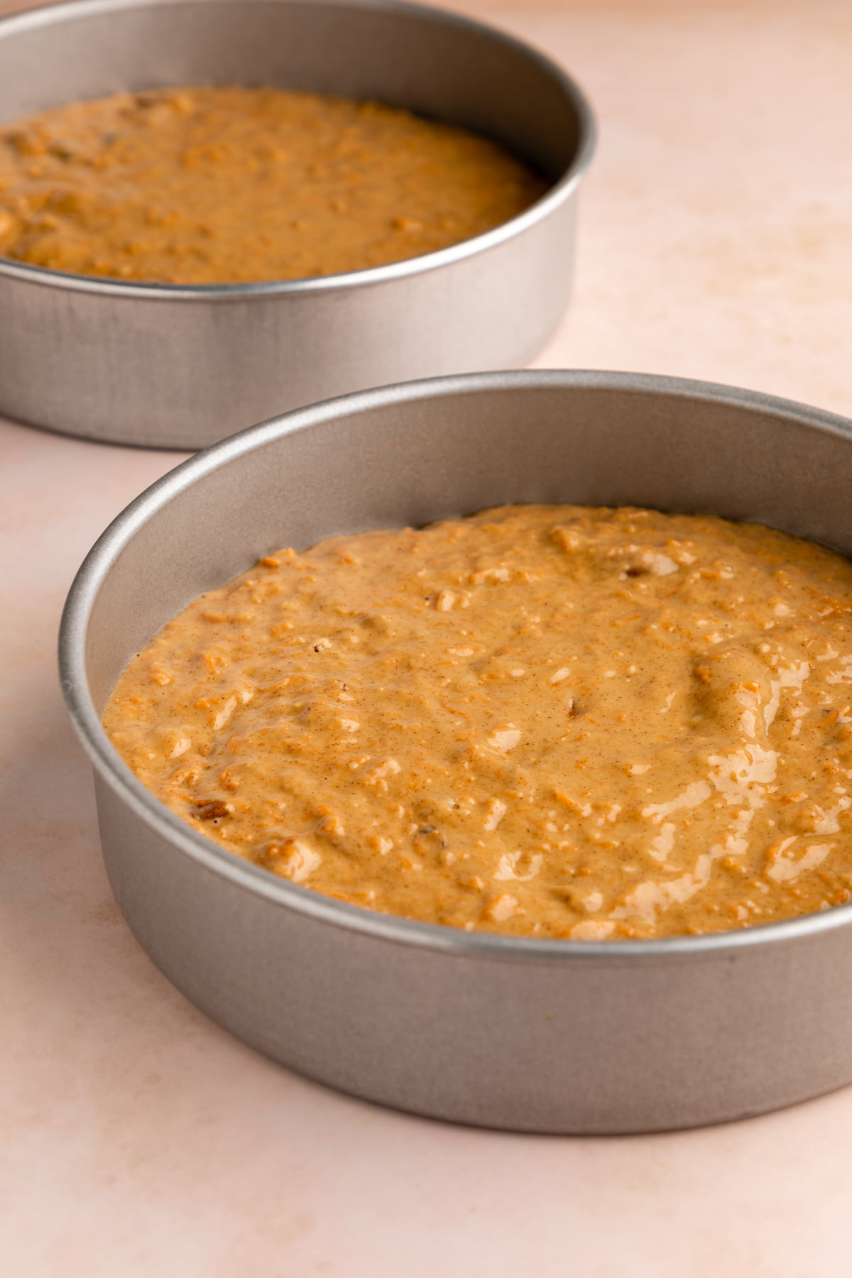 Vegan carrot cake batter in a cake pan.