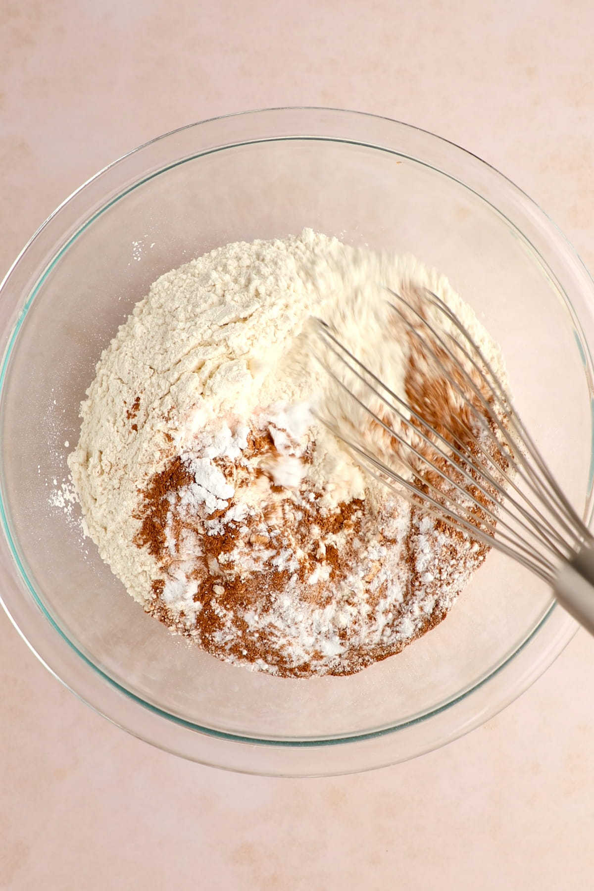 Mixing wet and dry ingredients for vegan carrot cake.