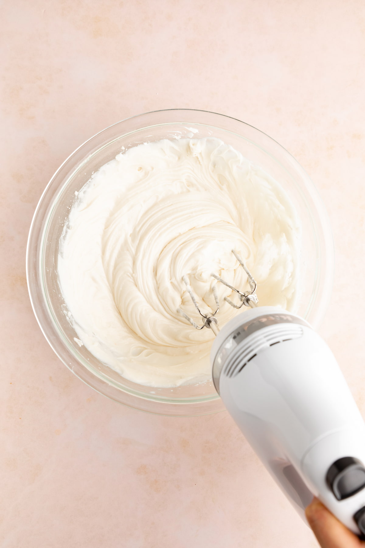 Vegan cream cheese being blended in a bowl.