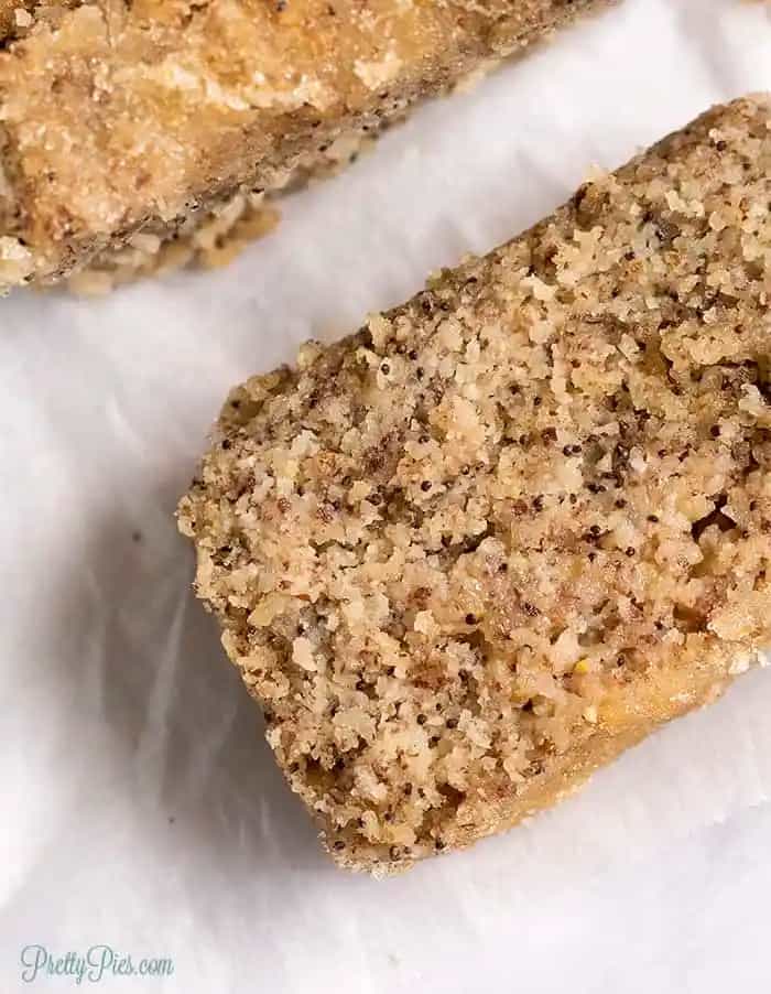 vegan and gluten-free poppyseed bread sliced up on white parchment paper