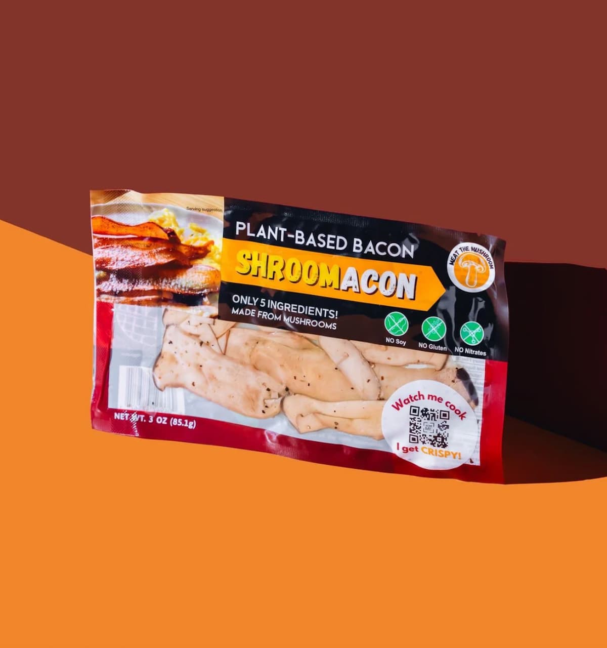 A package of Meat the Mushroom vegan bacon against an orange and brown background. 