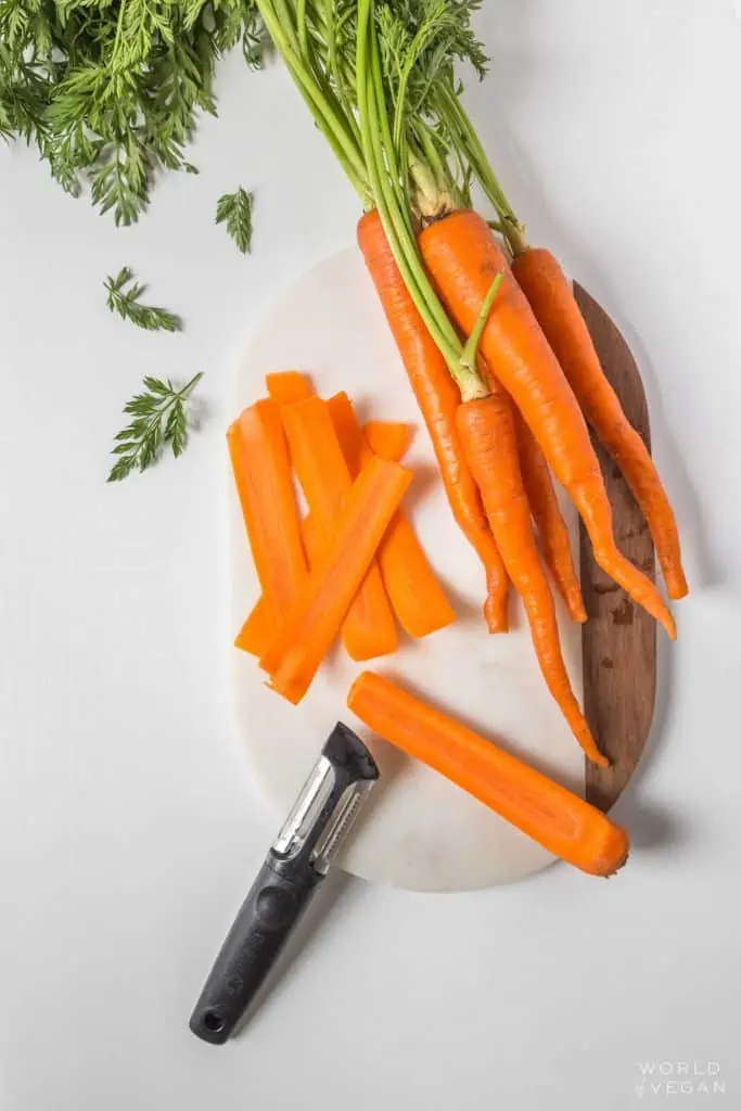 slicing carrots with a peeler