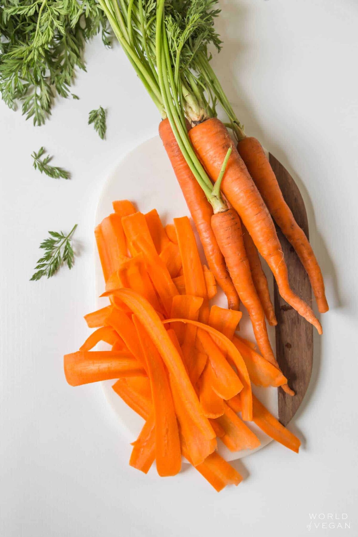 Thinly sliced carrots on a plate.