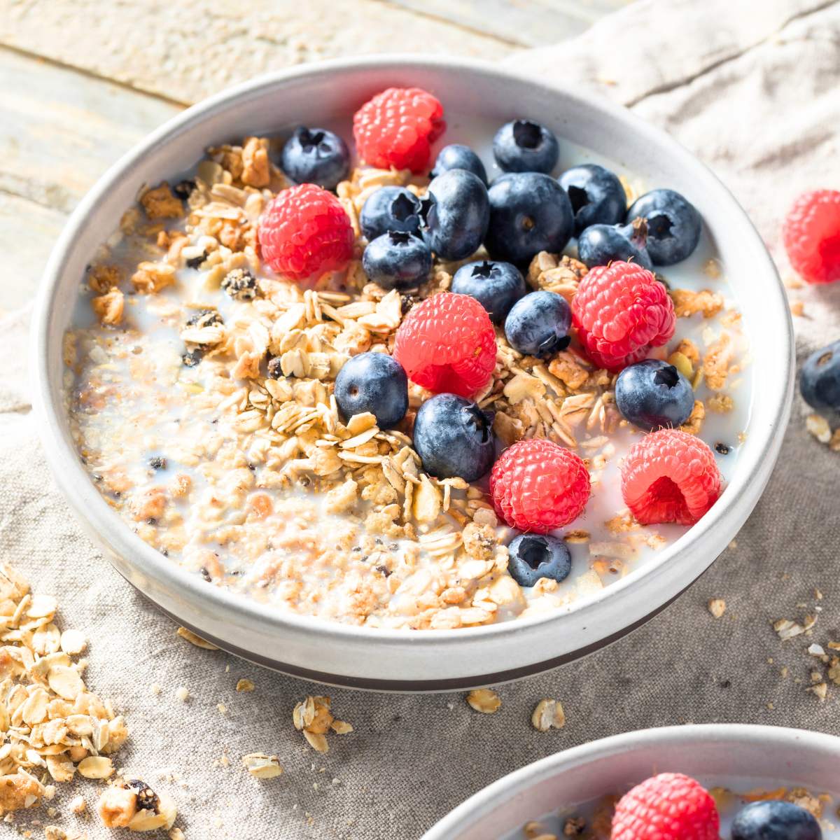 A bowl of vegan cereal topped with fresh berries.