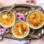 Vegan creme brulee serve in ramekins with spoons.